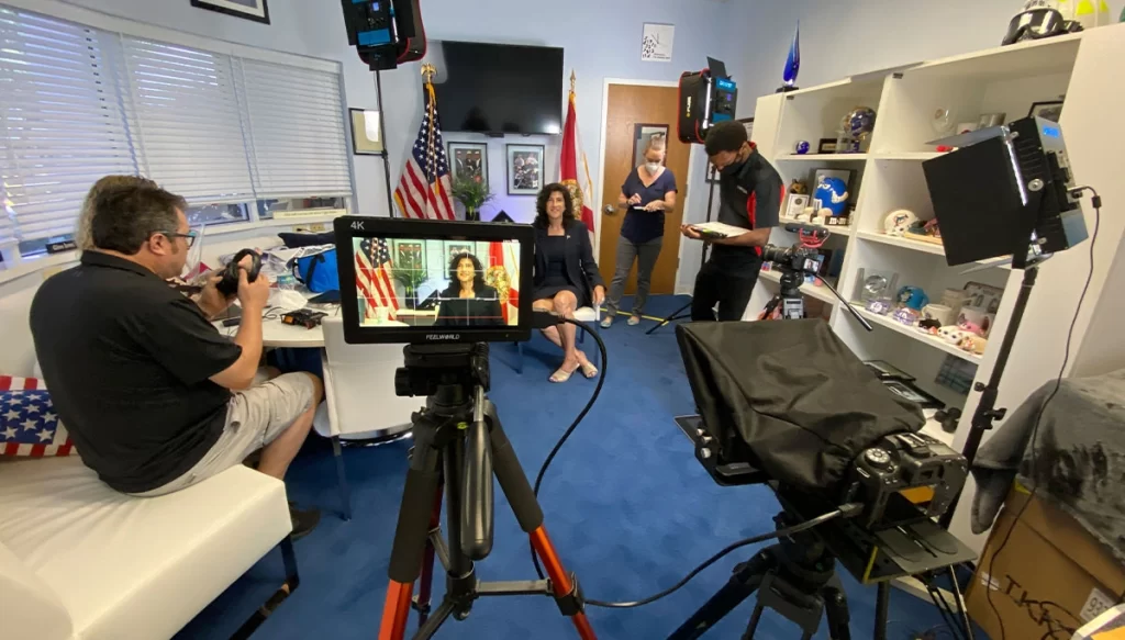 film crew with equipment in an office