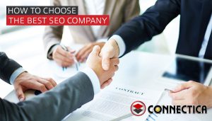 two men shake hands over a table