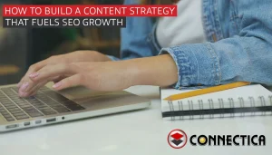 close up of woman typing on her laptop with a notepad