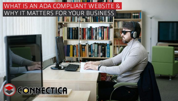 man with sun glasses and headphones reads a brail book infront of a desktop computer
