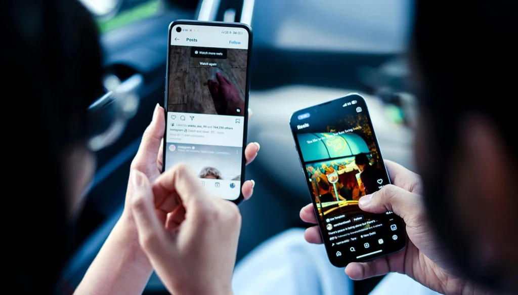 a man and woman looking at instagram reels on their cellphones