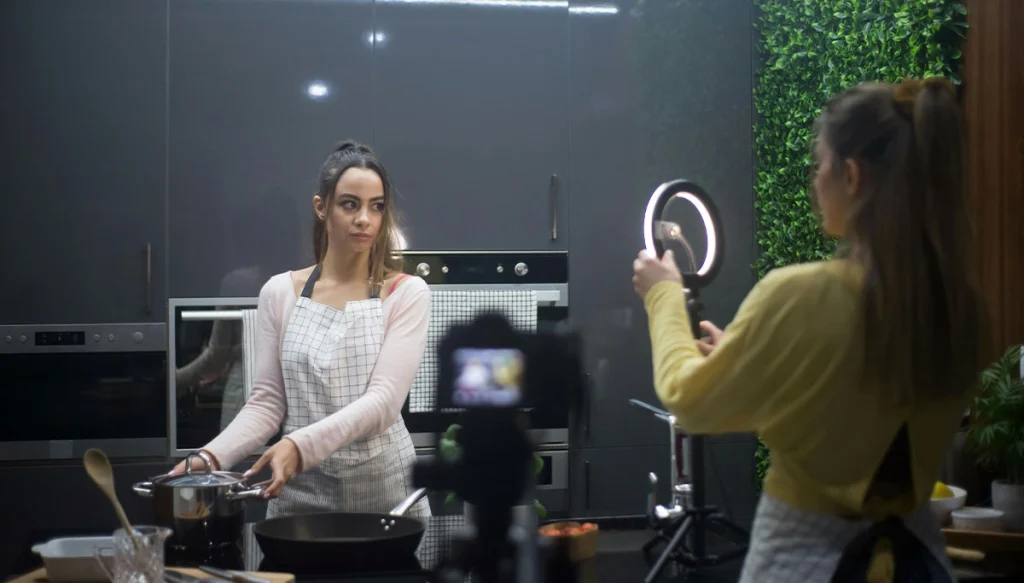 two woman filming a video on cooking