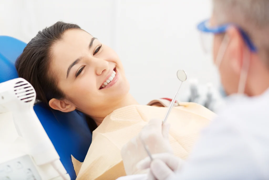 Image Of Smiling Patient Looking At The Dentist